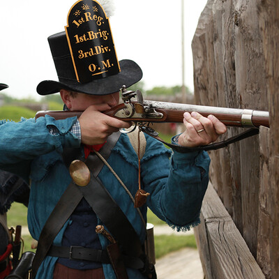 A realistic close‑up of a 9mm bullet and a .45 ACP bullet lying side by side on a matte black surface, showing scale and grain markings. Alt: comparison of 9mm and .45 ACP bullet sizes and grain weights.