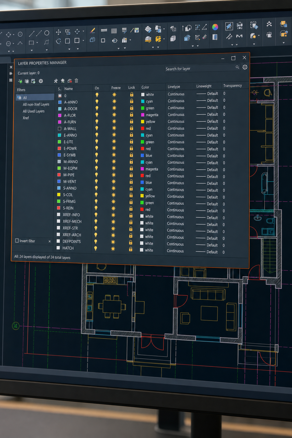A realistic overhead view of a computer screen showing the AutoCAD Layer Properties Manager panel with multiple color-coded layers listed, a floor plan visible in the drawing area behind it. Alt: AutoCAD Layer Properties Manager showing organized color-coded drawing layers.