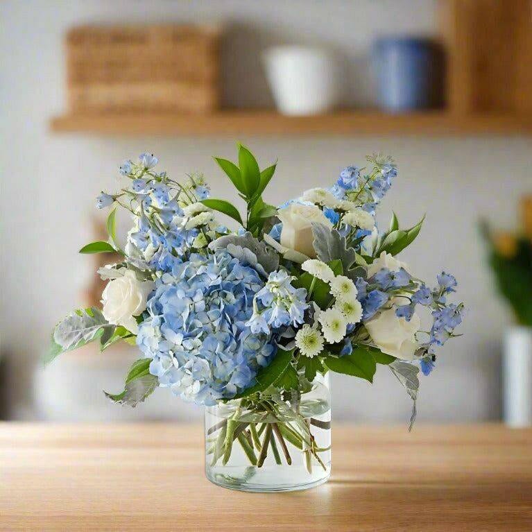 A realistic scene of a friendly local florist arranging funeral flowers behind a wooden counter, with soft lighting and