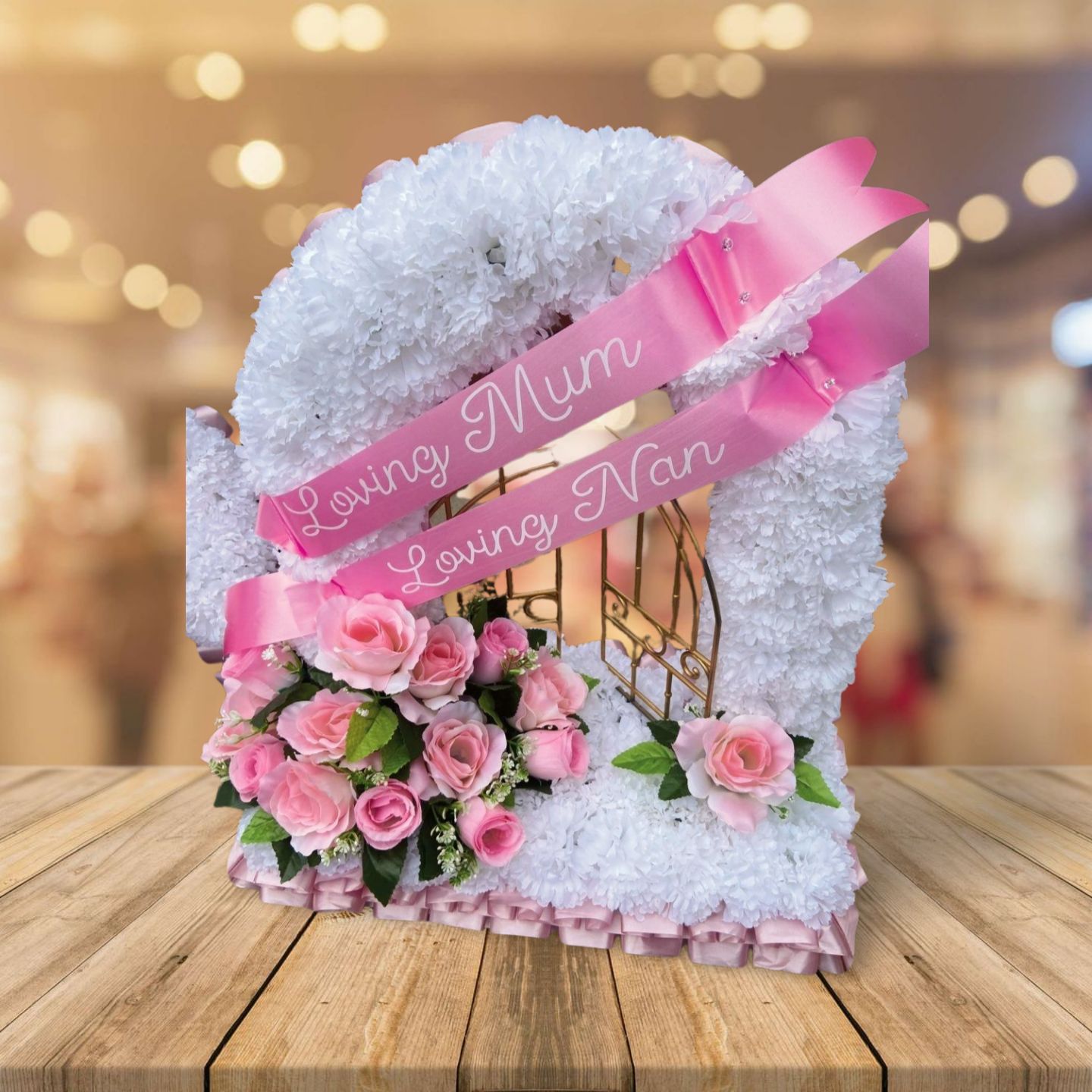Heart-shaped artificial wreath placed at a grave, symbolizing gates of heaven, alt: heart-shaped artificial flower wreat