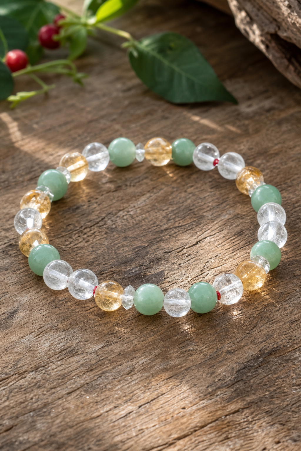 A realistic close‑up of a handcrafted crystal bracelet featuring citrine, green aventurine, and clear quartz beads on a 