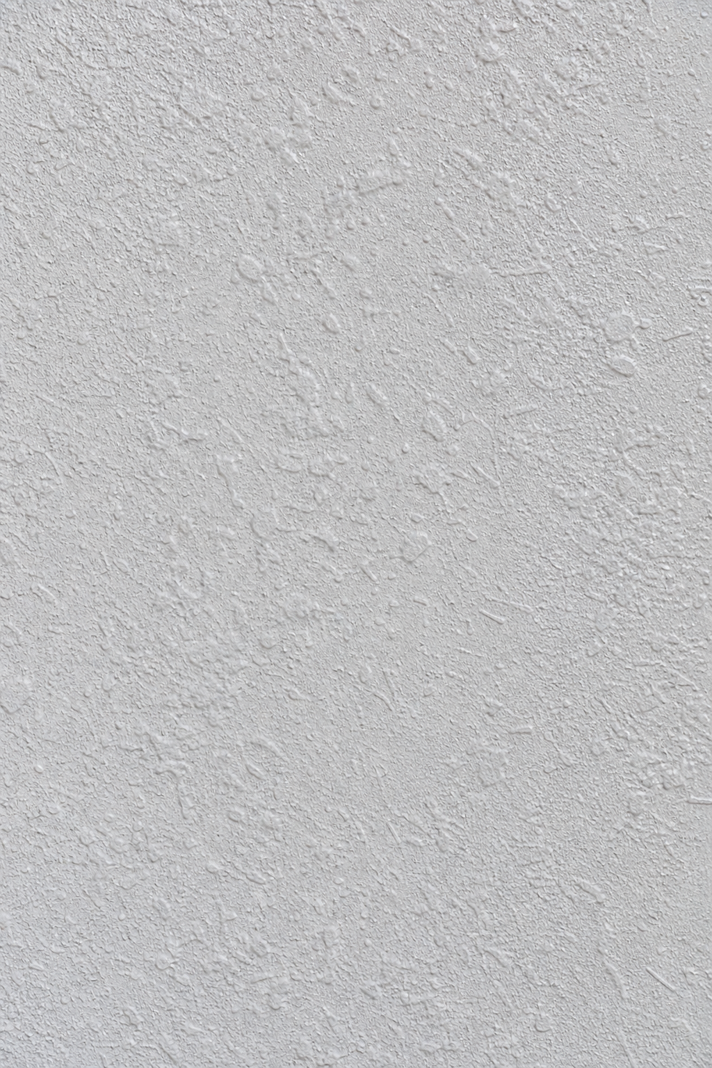 A photorealistic close-up of textured stucco with a fresh coat of paint, realism style. Alt: textured stucco wall with new paint.