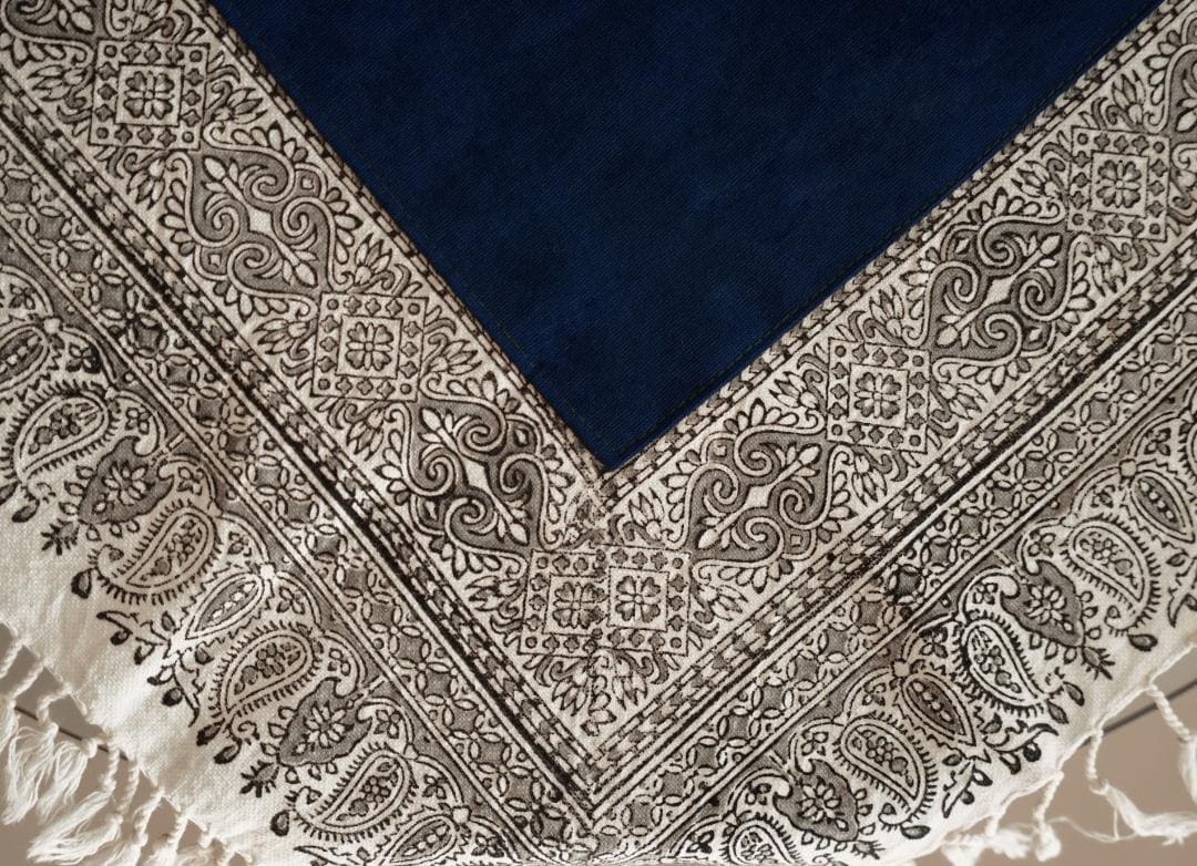 Carved wooden blocks and hand-printed cotton textile showing block print tablecloth craftsmanship.