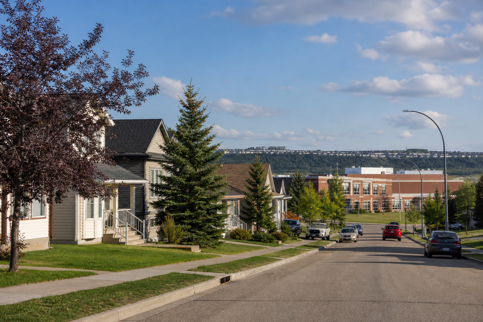 A photorealistic neighbourhood scene of North East Calgary with modest single‑family homes, a school in the background, alt: "North East Calgary budget‑friendly community"