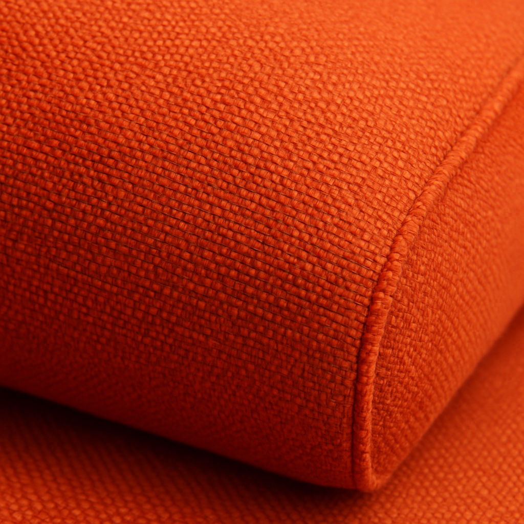 A close‑up of Sunbrella cushion fabric showing vibrant, fade‑proof color and textured weave. Alt: Sunbrella cushion material detail.