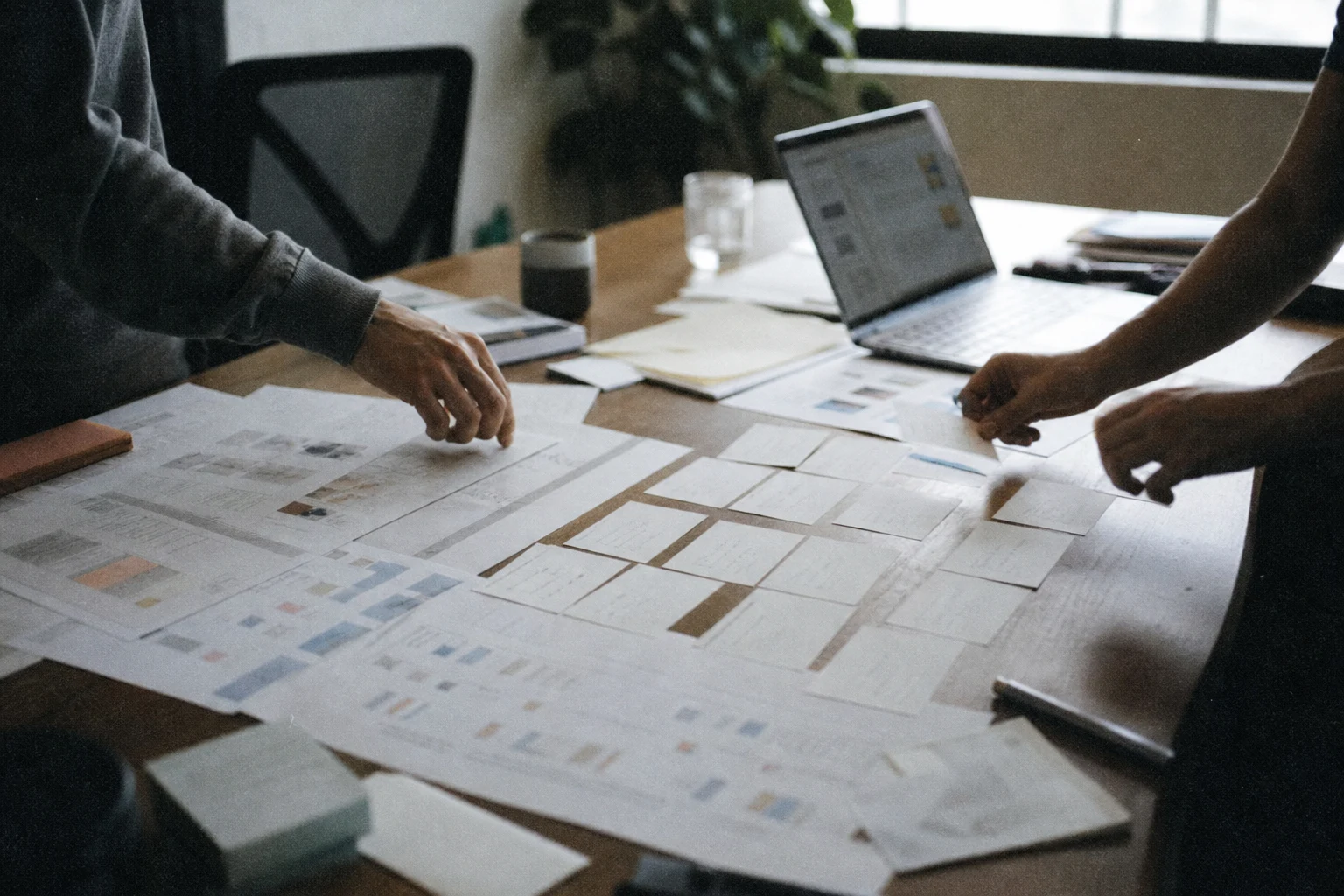 Best Content Strategy Agency Services 7 Documentary-style photo of content spreadsheets being sorted on a table