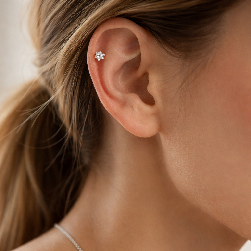 A photorealistic close-up of a woman’s ear wearing a white-gold diamond cartilage stud paired with a slim silver chain necklace, soft natural light highlighting the sparkle, realistic style