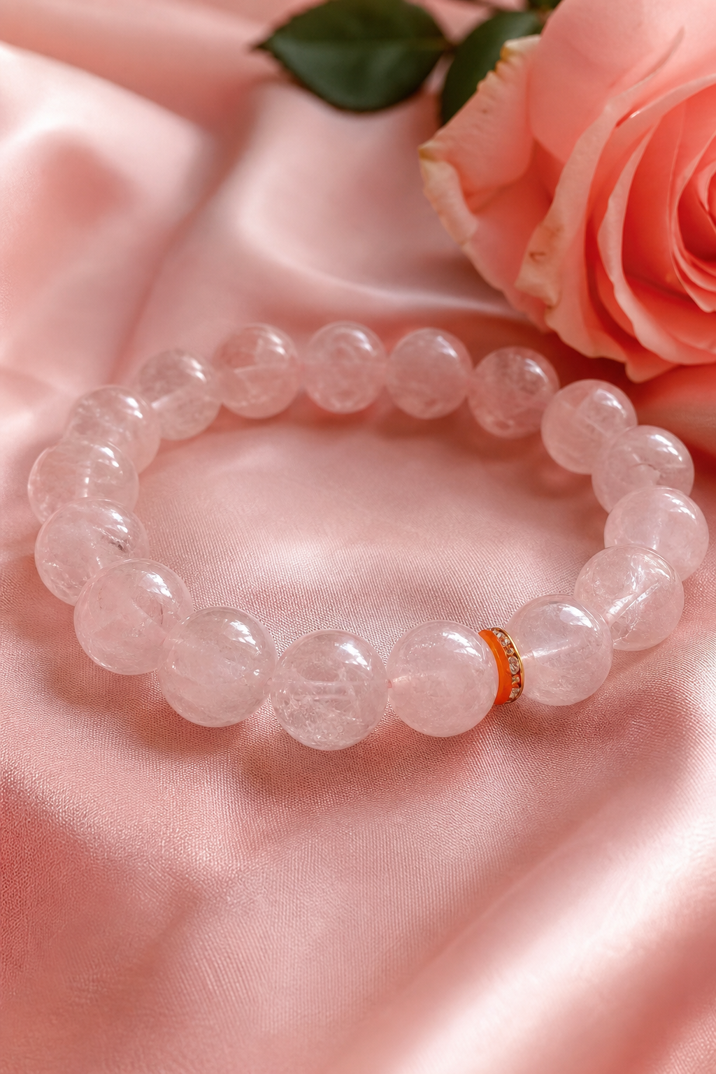 A photorealistic close-up of a rose quartz bracelet lying on a soft pink silk cloth, natural daylight, shallow depth of field showing the translucent pink beads with internal fractures, warm and gentle atmosphere. Alt: Rose quartz healing bracelet on pink silk for heart chakra healing.