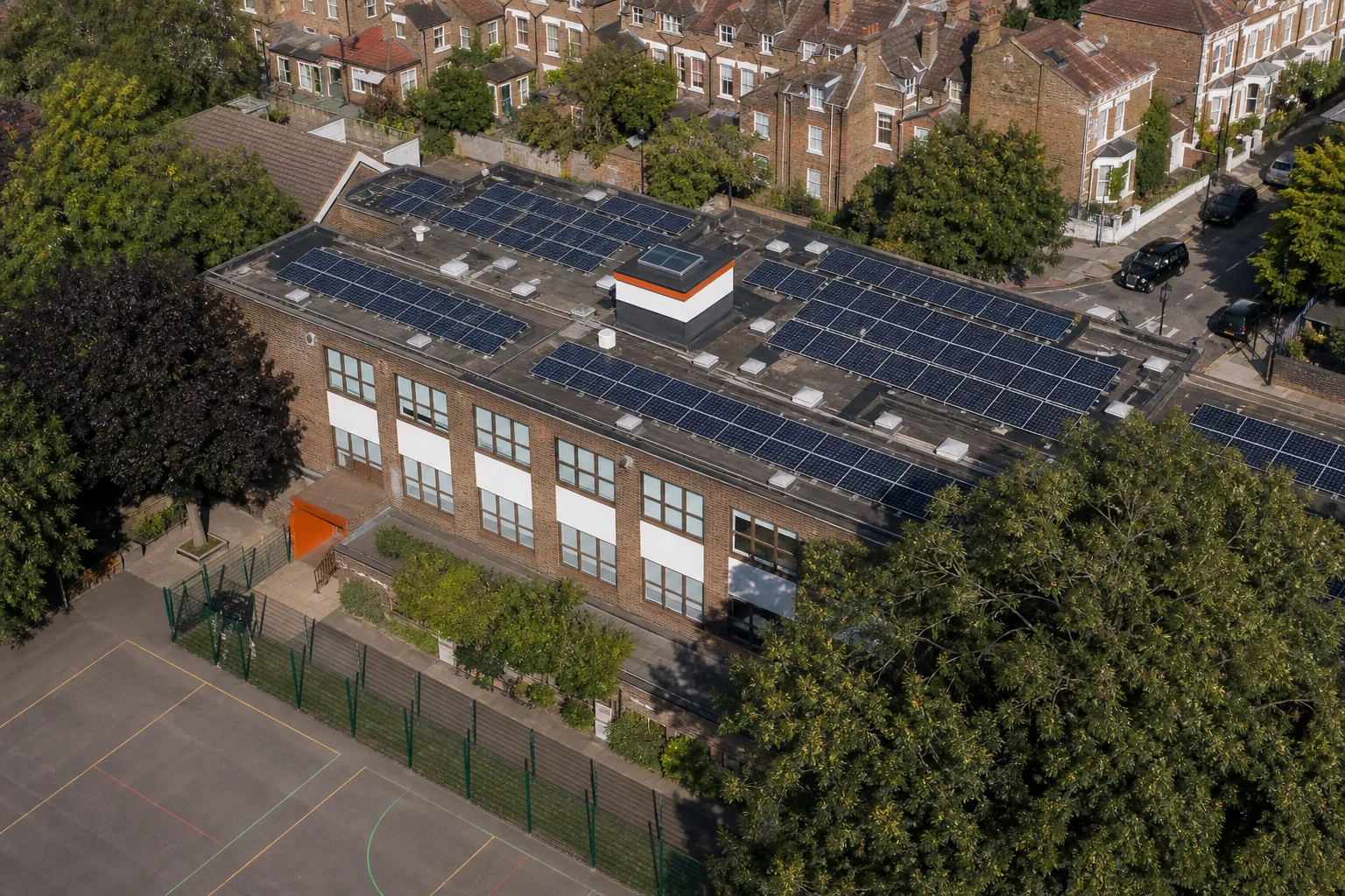 Rooftop solar panels on a UK school checked for shade and soiling.