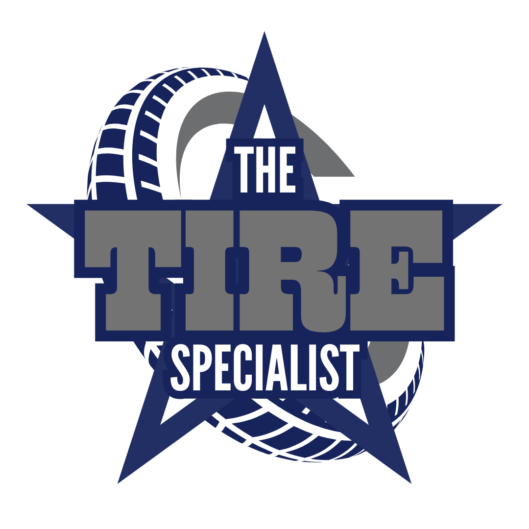 A photorealistic scene of a fully equipped mobile tire service truck pulling up to a large commercial truck on a highway shoulder, technician wearing branded shirt, tools and spare tires visible, clear sky, Fort Worth skyline in background. Alt: mobile tire service for commercial trucks in Fort Worth