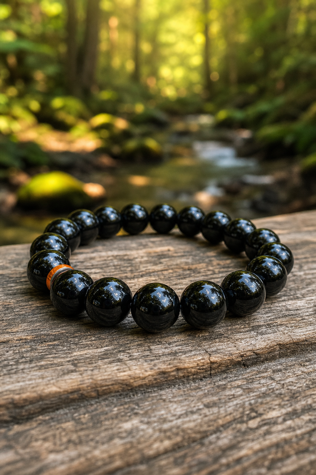 A photorealistic close-up of a smooth black obsidian bracelet on a wooden table, natural light reflecting off the glossy beads, with a soft forest background. Alt: Black obsidian bracelet with shiny volcanic glass beads
