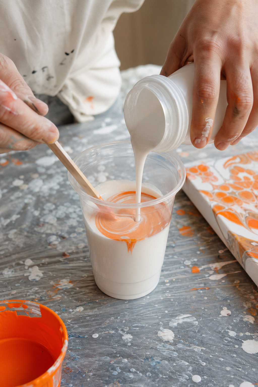 Realistic close-up of a person stirring acrylic paint and pouring medium in a plastic cup with a wooden stick. The mixture is smooth and flowing. Soft natural light. Alt: Mixing acrylic paint with pouring medium for fluid art.