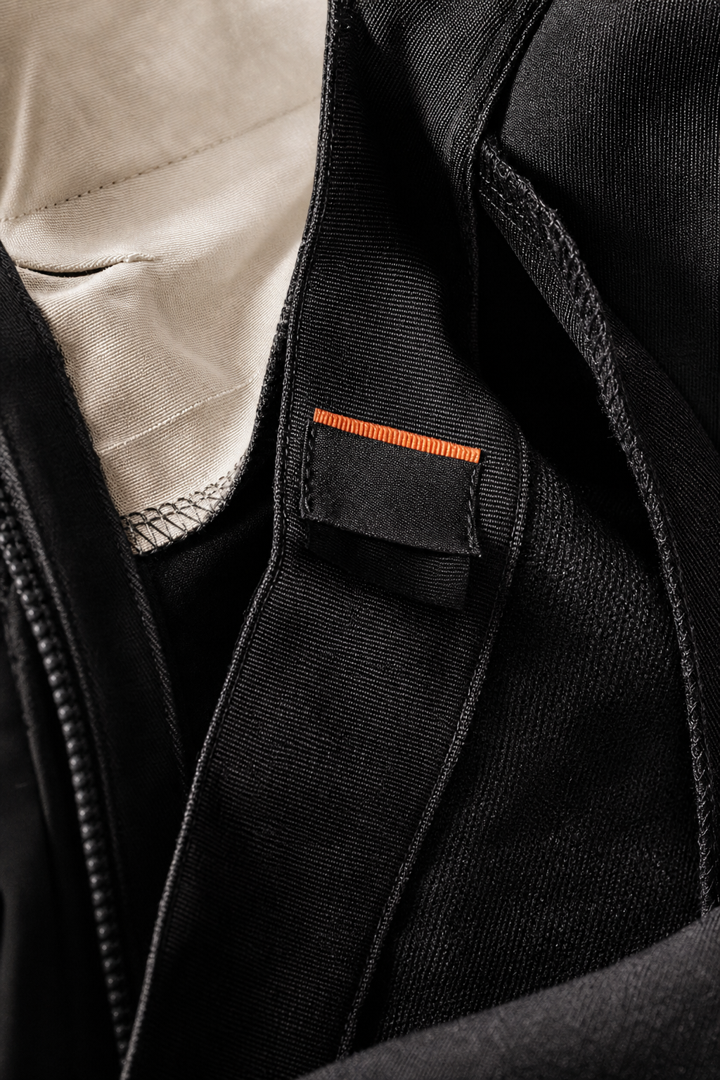 A close-up of the inner seam and stitching of a pair of Stella McCartney trousers, showing the fabric texture and label. Alt: Detail of Stella McCartney trouser craftsmanship.