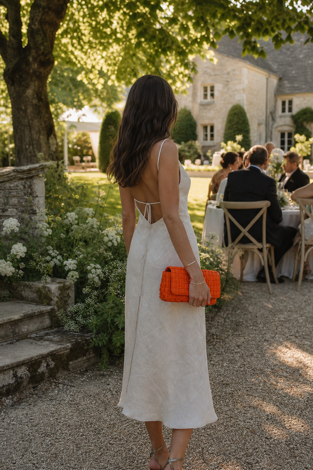 A photorealistic garden wedding scene with a guest wearing a Reformation linen midi dress, soft sunlight filtering through trees, natural textures highlighting sustainable fashion.